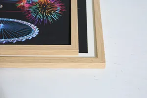 Close-up of a natural wood picture frame corner showing its fine grain texture