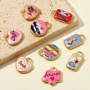 Detailed view of assorted colorful enamel heart and star charms on textured stone