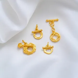 Detailed view of 24K gold plated OT buckles with traditional Ruyi and coin patterns