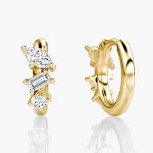 Detailed view of 14k gold plated moissanite earrings with asymmetrical three-stone design.