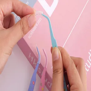 Detailed view of colorful curved stainless steel tweezers for DIY craft and stickers