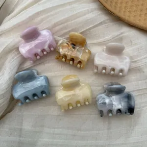 Elegant collection of marble patterned French style hair claw clips in assorted soft colors.