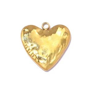 Detailed close-up view of a hammered gold stainless steel heart pendant with luster.