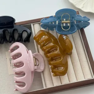 Close-up of minimalist Korean style hair claw clips in various colors in a display tray