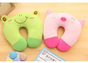 Close-up of cute cartoon frog and pig plush U-shaped travel pillows for comfortable neck support
