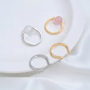 Close-up of 14K gold plated copper hollow open ring bases for DIY accessory assembly.