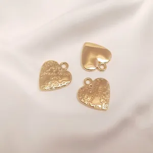Close-up of 14K gold-filled heart charms with vintage 'Made with love' engraving