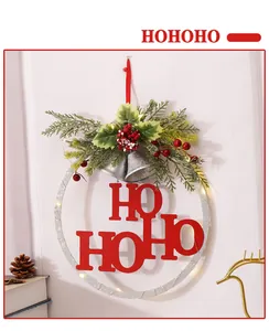 Festive Christmas wreath with red 'HO HO HO' letters and warm LED lights, lifestyle view.
