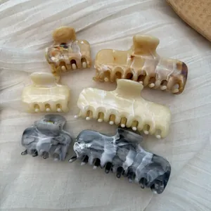 Detailed macro view of French style marble pattern hair claw clips in varied colors