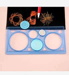 Spirograph drawing set showing multi-functional blue ruler and intricate geometric patterns.