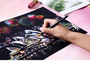 Detailed view of hand using a dual-ended pen to scratch a colorful Sydney night city scene