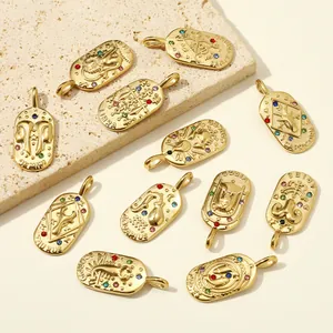 Detailed macro view of vintage twelve zodiac sign oval gold stainless steel pendants set