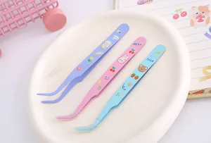 Close-up of cute cartoon stainless steel tweezers for DIY journaling and crafts