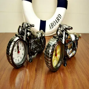 Detailed view of creative motorcycle-shaped alarm clock ornaments on a wooden surface