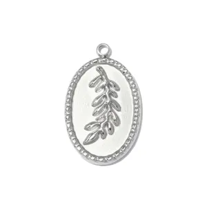 Close-up of a silver stainless steel oval pendant with embossed leaf design