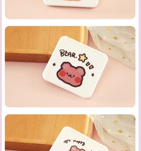 Primer plano de un espejo plegable portátil blanco con un dibujo de oso.