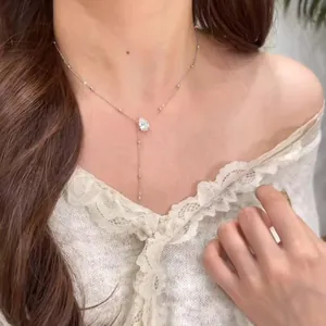 Gros plan d'un collier à pampilles en moissanite plaqué or 14 carats élégant sur un modèle