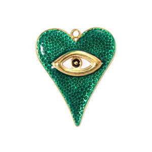 Close-up of a textured green enamel heart pendant with a gold-tone evil eye design detail.