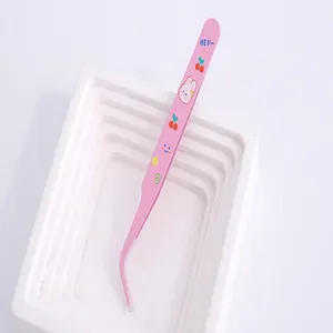 Close-up of pink cartoon stainless steel tweezers for DIY journaling