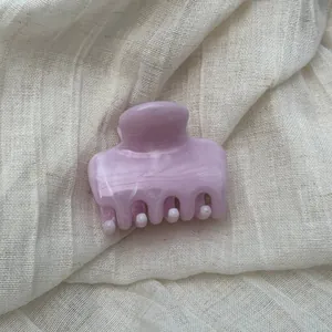 Detail shot of a light purple hair claw clip with a marble ink texture