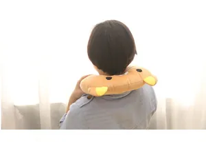 Back view of a woman using a cartoon plush U-shaped neck pillow for travel comfort