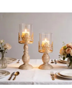 Vintage European iron candle holders with ornate hollow design and glass shades
