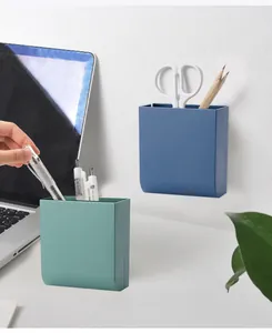 Detail showing wall-mounted and desktop stationery pen holders in blue and green plastic