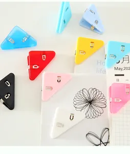 Detail of colorful triangular plastic corner clips organizing papers and notebooks