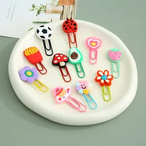Assorted cartoon-shaped metal paperclips in various colorful designs on a white tray.