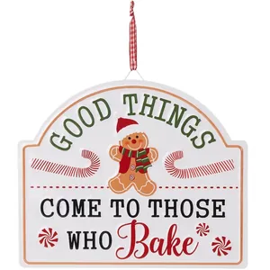 Festive Christmas tin sign featuring a gingerbread man and baking-themed quote decor.
