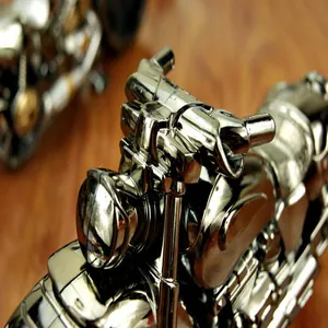 Macro view of a chrome motorcycle alarm clock detailing the handlebars and headlight