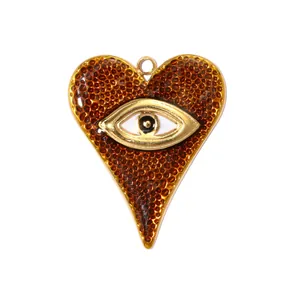 Close-up of heart-shaped evil eye pendant with brown enamel texture and gold accents