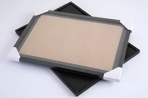 Detailed macro shot of black scratch art picture frames with white corner protectors