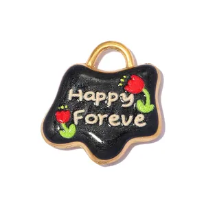 Macro view of a black enamel flower charm pendant with Happy Forever text and red rose detail