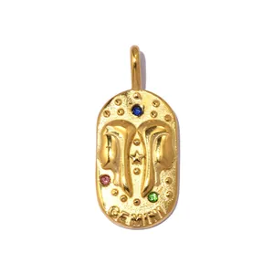 Detailed macro view of a vintage gold Gemini zodiac pendant with colorful stones