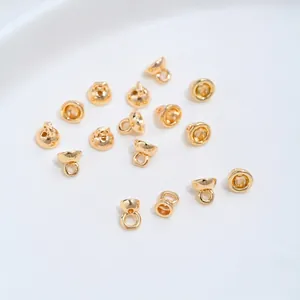 Detailed view of polished 14K gold plated bell end caps with loops for jewelry making