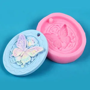 Detail of oval butterfly rose silicone mold showing pink mold and blue embossed cast