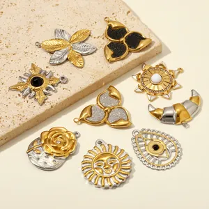 Detailed view of assorted gold and silver stainless steel jewelry pendants in various shapes