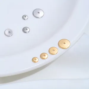 Close-up of golden and silver stainless steel flat round spacer beads for DIY