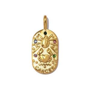 Close-up of golden oval zodiac pendant featuring Cancer crab motif and colorful stones