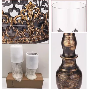Vintage European style iron candle holder with ornate hollow patterns and glass sleeve