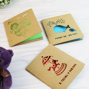 Detail of unique hollow-out kraft greeting cards with whale and carousel designs