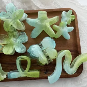 Collezione di mollette per capelli verde sfumato a forma di fiore e stella