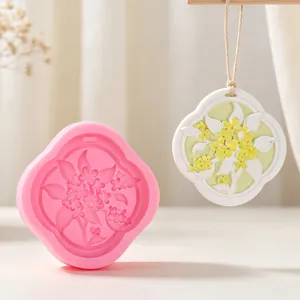 Floral silicone mold for plaster aromatherapy pendant with finished white wax sample view