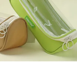 Close-up of a large capacity transparent pencil case with green fabric trim