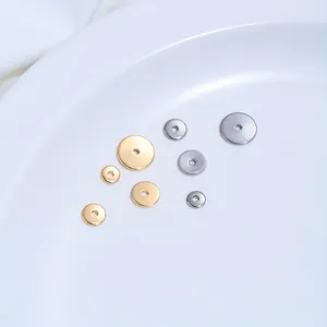 Macro view of polished stainless steel flat disc spacers for jewelry making