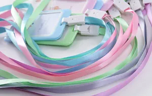 Detailed macro shot of various pastel-colored lanyards and ID card holders for campus