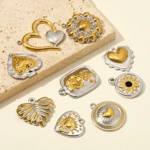 Macro view of various two-tone stainless steel heart and flower pendants for DIY jewelry
