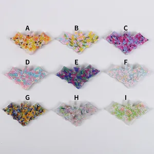 Detailed view of nine colorful bat-shaped silicone skin picking fidget toys with beads.