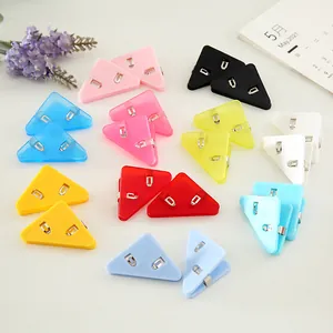 Colorful plastic triangular corner clips for student paper and office file organization